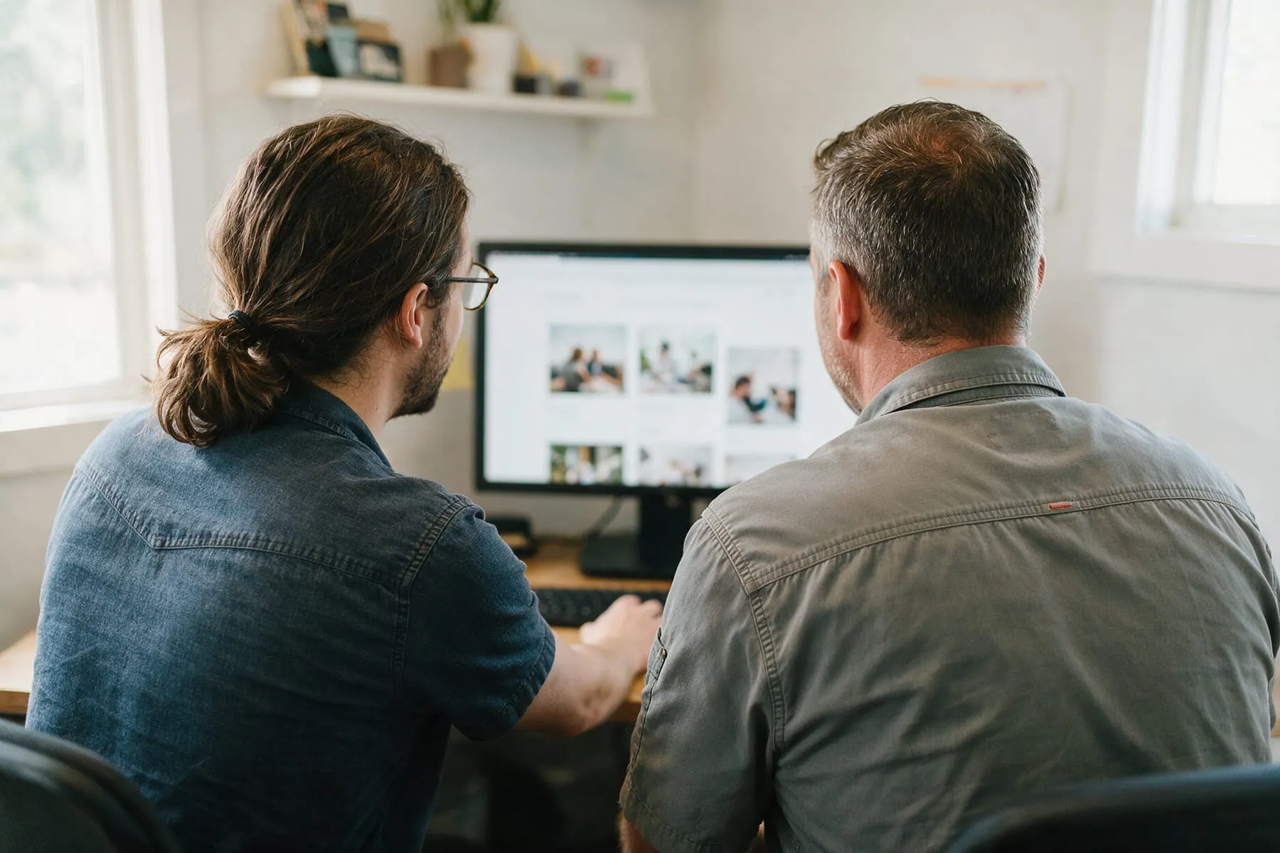 Web designer reviewing a website layout with a contractor