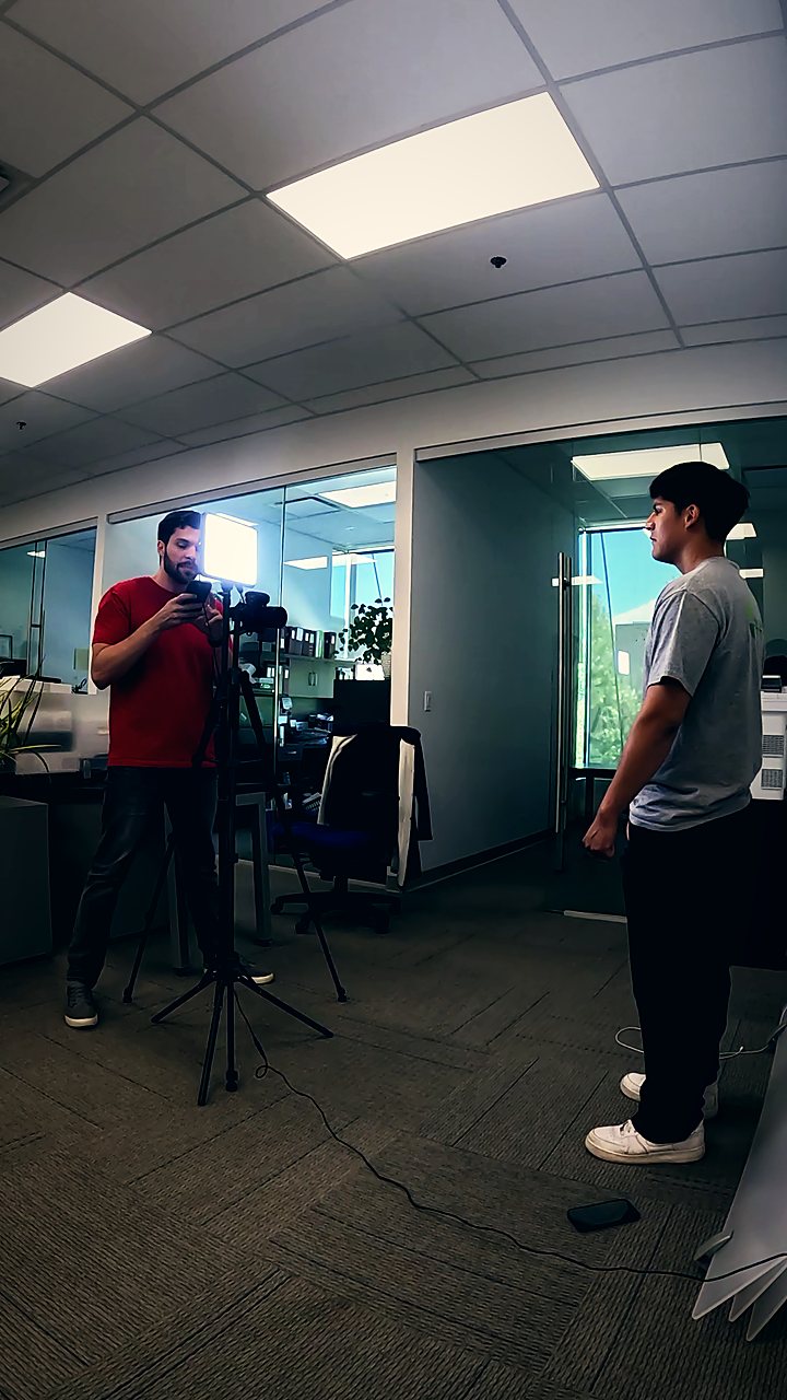 Camera and tripod set up in an office